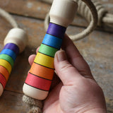 Mader Kreiselmanufaktur Children's Skipping Rope Rainbow Handles in an adult hand.