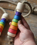 Mader Kreiselmanufaktur Children's Skipping Rope Rainbow Handles in an adult hand.