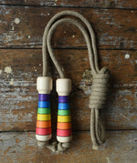 Mader Kreiselmanufaktur Children's Skipping Rope Rainbow Handles placed on a wooden surface in the Babipur playroom.