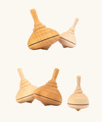 A collection of Mader classic spinning tops in various types of wood.