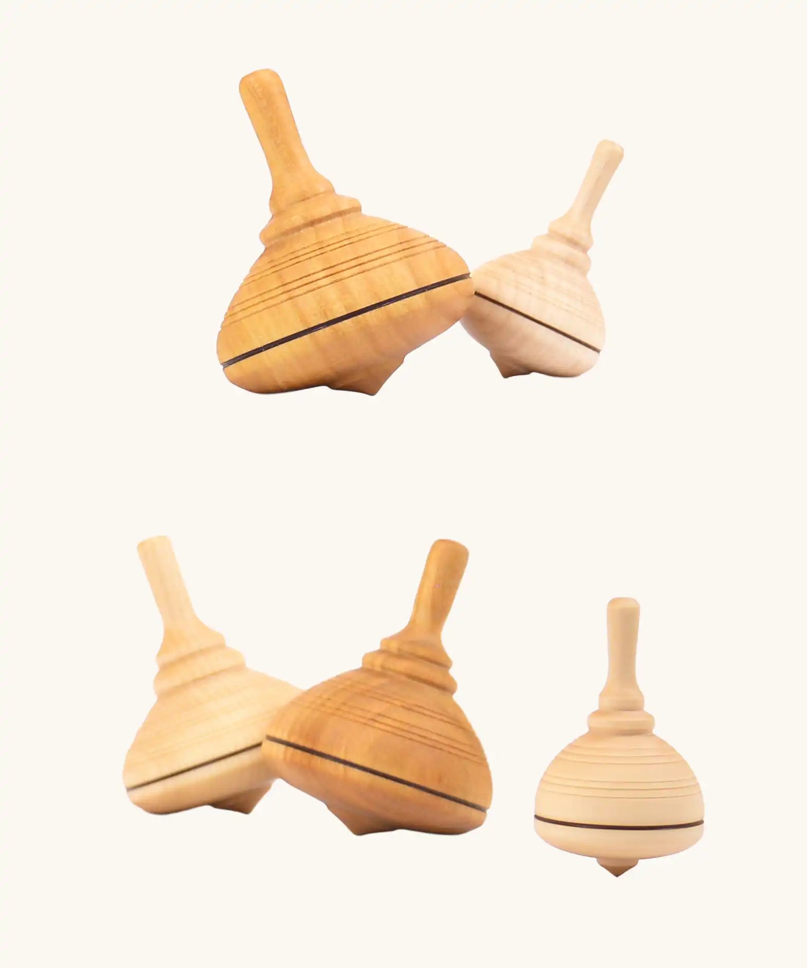 A collection of Mader classic spinning tops in various types of wood.