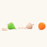 Mader Kreiselmanufaktur Coloured Profi Throw Wooden Spinning Tops in  three different colours. Green, natural and orange.