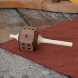 Mader Dice Spinning Topplaced on a wooden desk in the Babipur playroom.