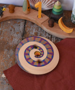 Mader Disc spinning Top Geometric blurred in motion, spinning on a wooden desk in the Babipur playroom.