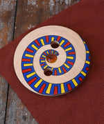 Mader Disc spinning Top Geometric placed on a wooden desk in the Babipur playroom.