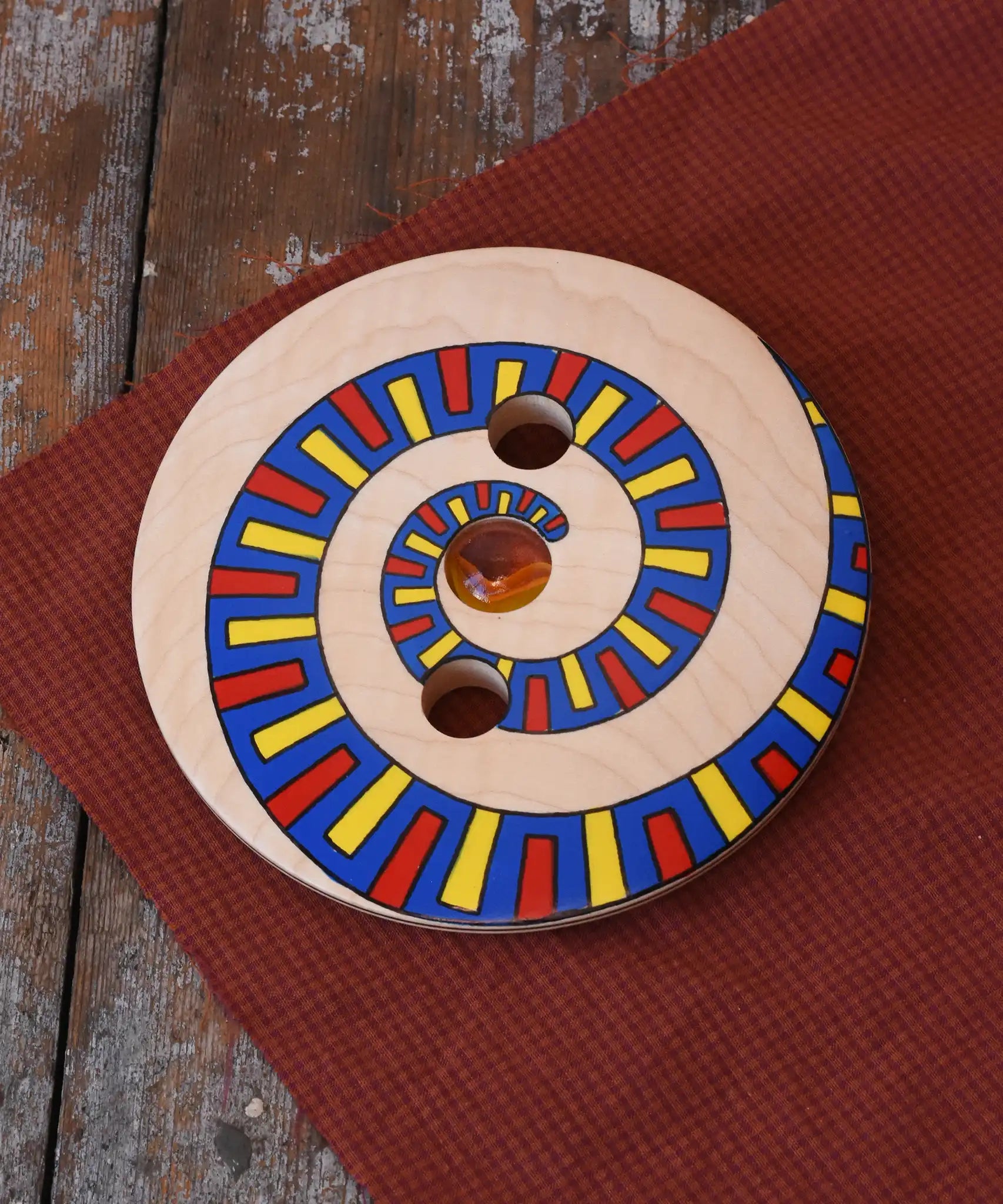 Mader Disc spinning Top Geometric placed on a wooden desk in the Babipur playroom.