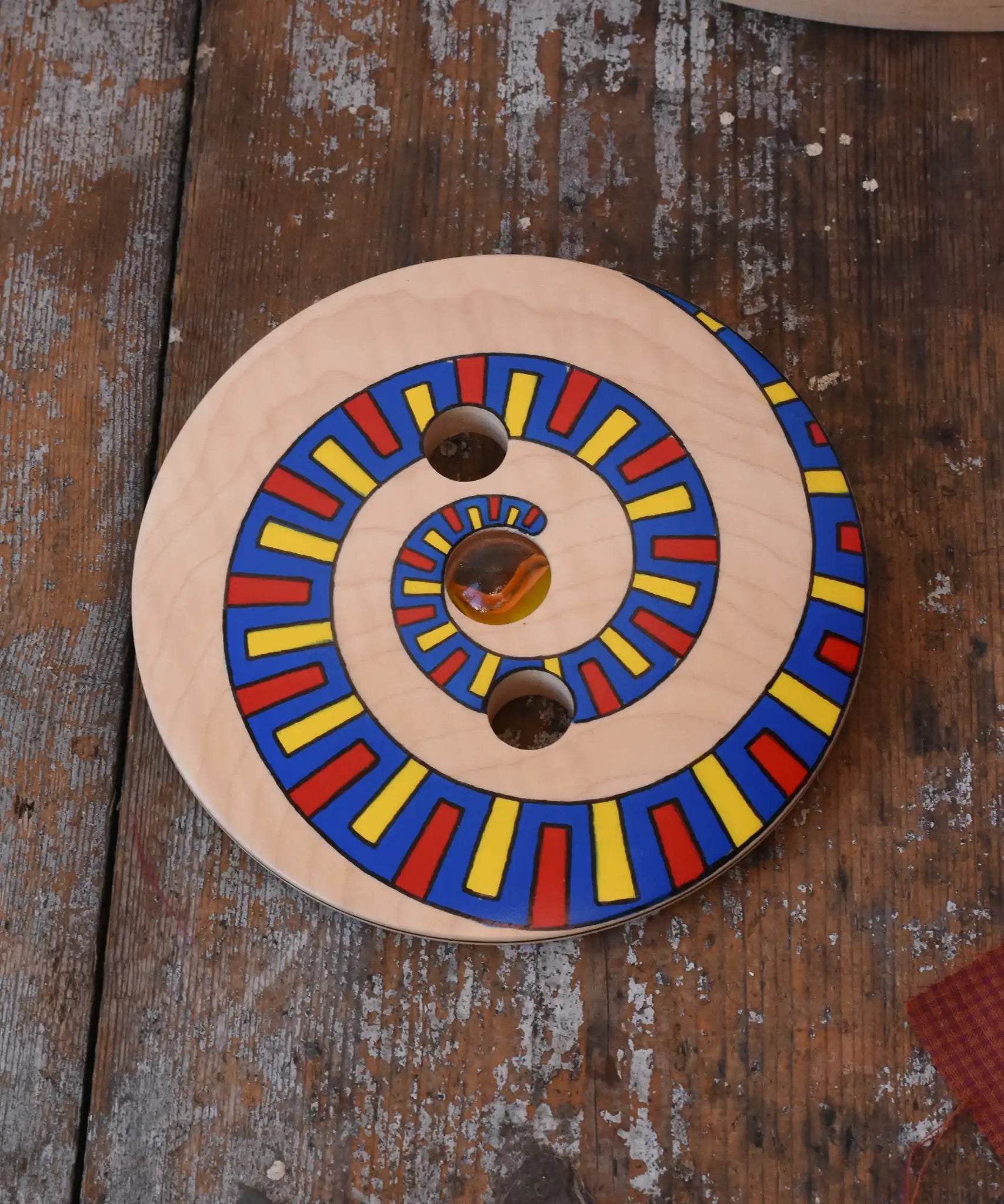 Mader Disc spinning Top Geometric placed on a wooden desk in the Babipur playroom.