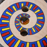 Close up of the pattern on the Mader Disc spinning Top Geometric placed on a wooden desk in the Babipur playroom.