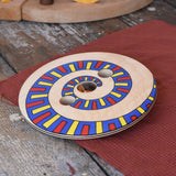 Mader Disc spinning Top Geometric placed on a wooden desk in the Babipur playroom.