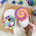 Four replacement discs for 'So And So' set. Two have been left blank and two have been coloured using Kitpas crayons. One has a swirl design and the other has a square colour block design. 
