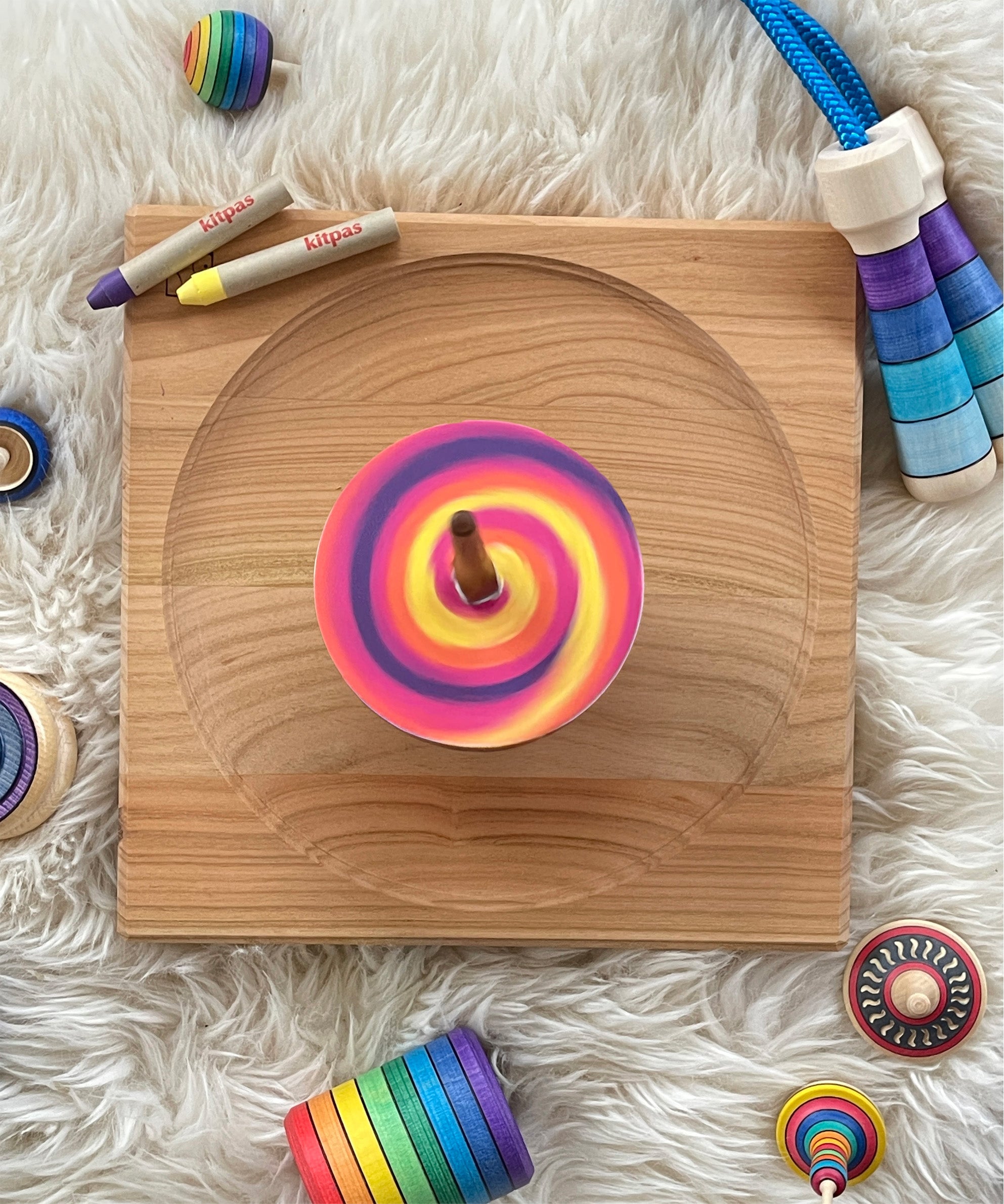 The Mader DIY Spinning Top Discs, coloured in so create a swirl pattern, and spinning on a Mader spinning plate.
