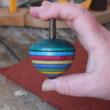 Mader dragon egg spinning top placed in an adult hand.