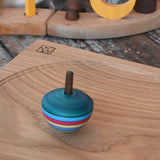 Mader dragon egg spinning top spinning in motion on an oak spinning plate in the Babipur playroom. 