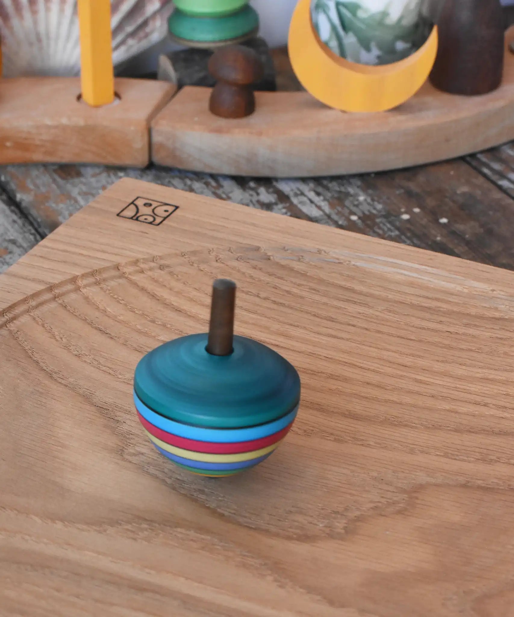 Mader dragon egg spinning top spinning in motion on an oak spinning plate in the Babipur playroom. 