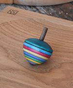 Mader dragon egg spinning top placed on an oak spinning plate in the Babipur playroom. 