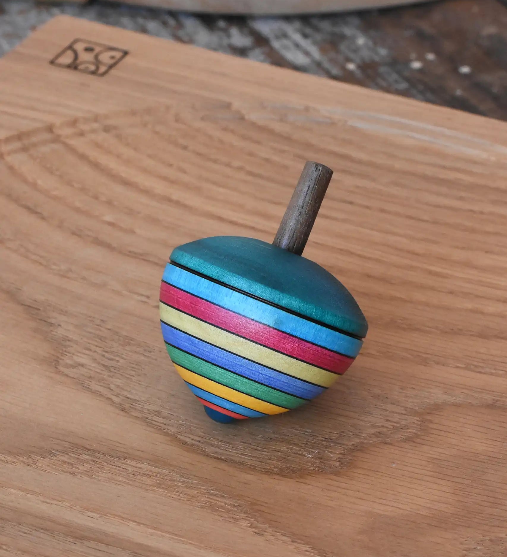 Mader dragon egg spinning top placed on an oak spinning plate in the Babipur playroom. 