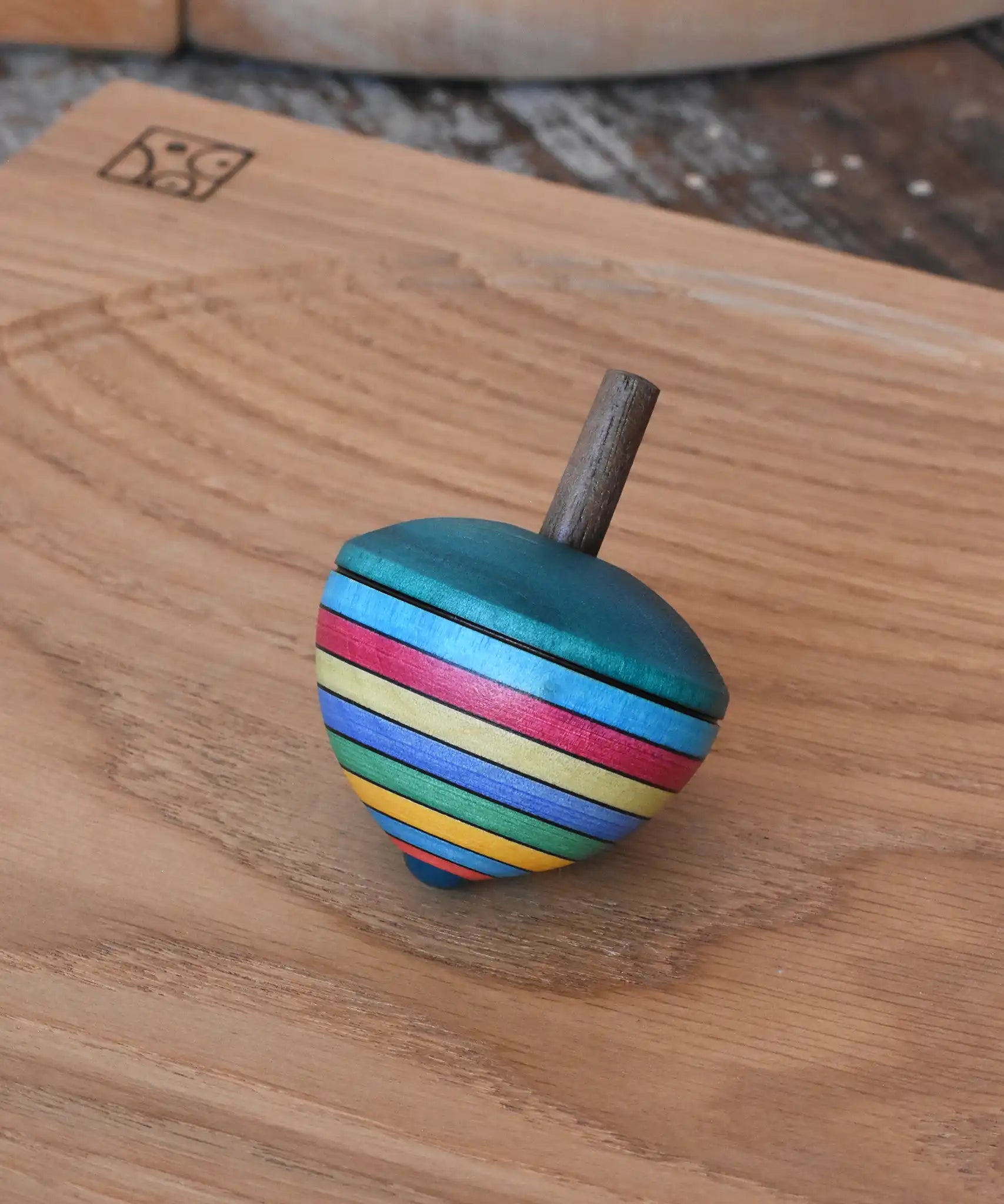 Mader dragon egg spinning top placed on an oak spinning plate in the Babipur playroom. 