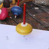 Mader Drawing spinning top spinning in motion on paper creating spin marks in the Babipur playroom.