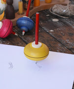 Mader Drawing spinning top spinning in motion on paper creating spin marks in the Babipur playroom.