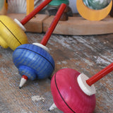 Mader Drawing spinning tops placed on a wooden desk in the Babipur playroom.