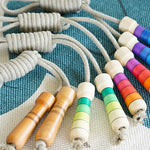 Mader eco-friendly linen skipping ropes laid out on a blue and white carpet