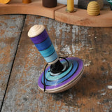 Mader my first spinning top toy with starter in purple placed on a wooden surface in the Babipur playroom. 