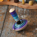 Mader my first spinning top toy with starter in purple placed on a wooden surface in the Babipur playroom. 