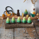 Mader Kreiselmanufaktur 5 tree spinning tops on branch placed on a wooden desk in the Babipur playroom.