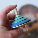 Mader flamenco spinning top in an adult's hand.