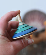Mader flamenco spinning top in an adult's hand.