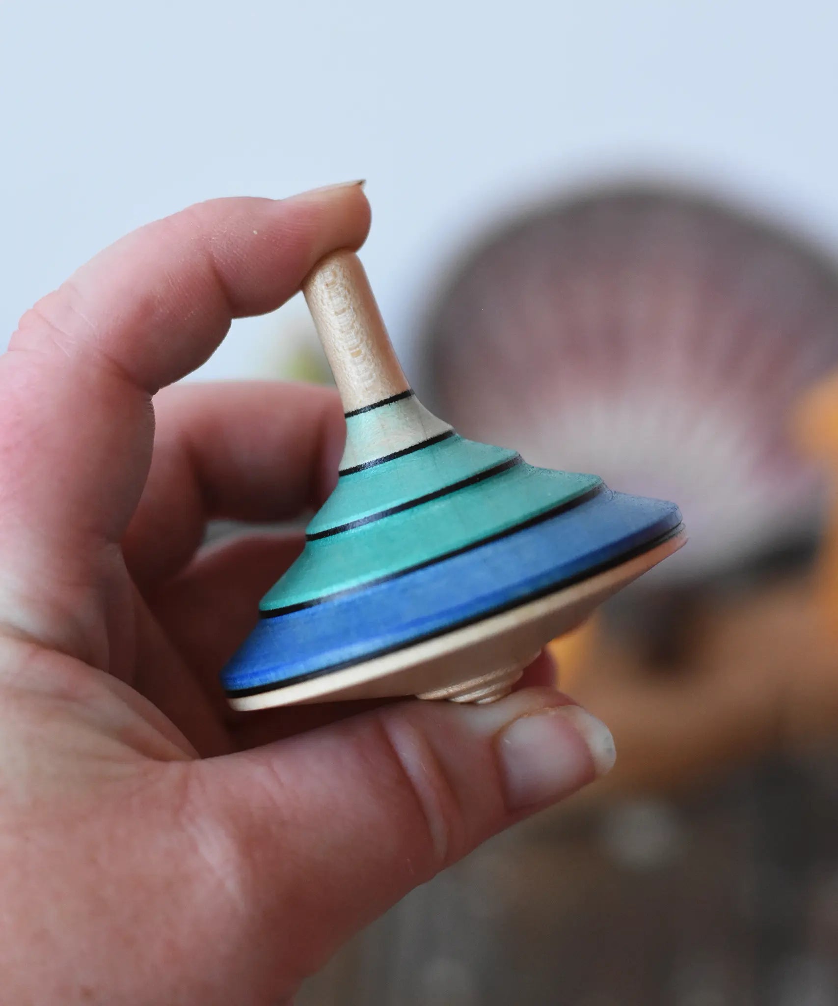 Mader flamenco spinning top in an adult's hand.