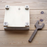 Mader Flower Press with Wooden Thread on a wooden surface in the Babipur playroom.