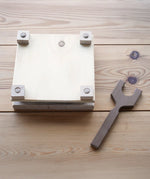 Mader Flower Press with Wooden Thread on a wooden surface in the Babipur playroom.