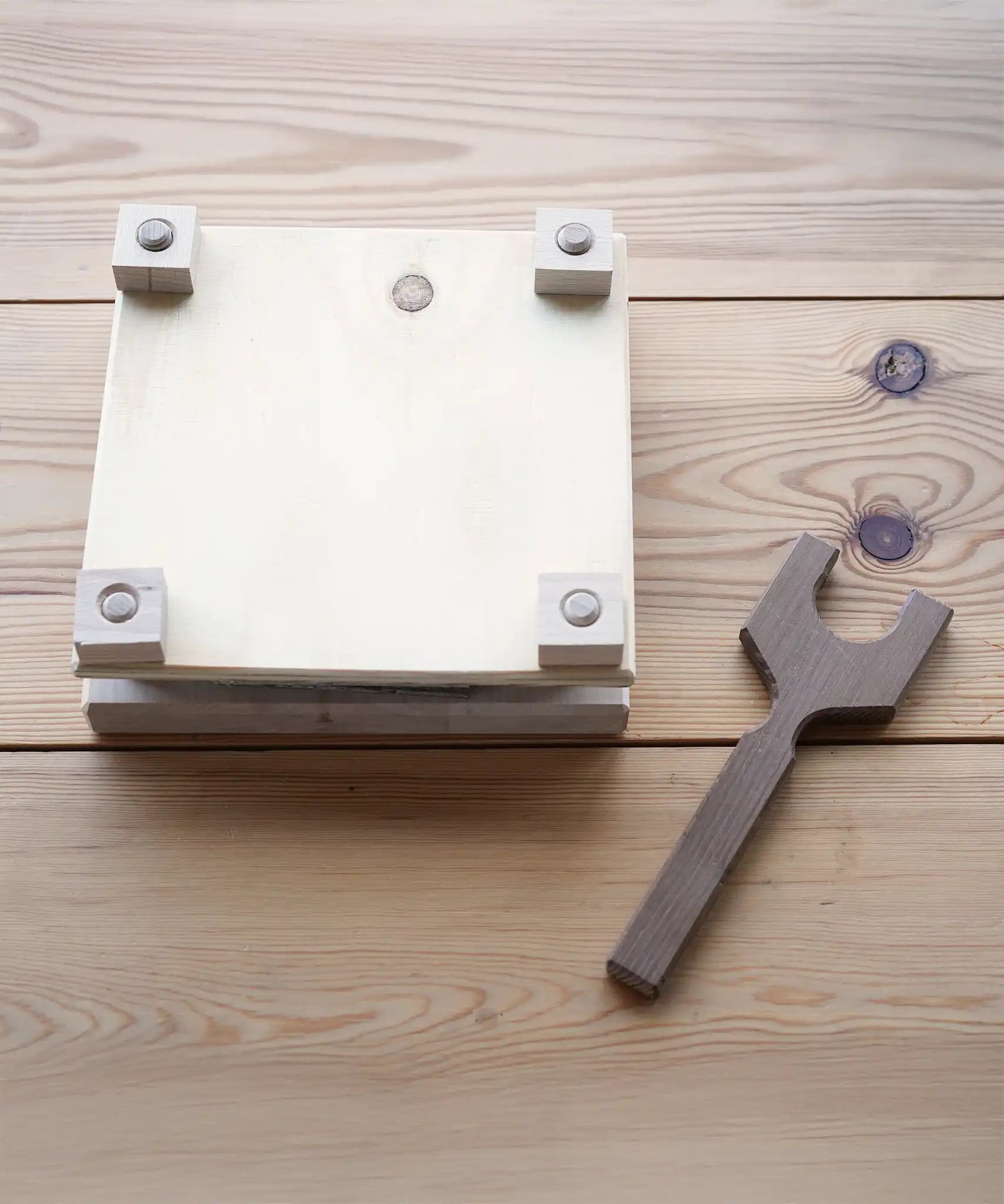 Mader Flower Press with Wooden Thread on a wooden surface in the Babipur playroom.