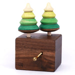 Mader Kreiselmanufaktur forest Edelweiss music box. A wooden wind up musical box with two slots for the green tree shaped spinners on the top.