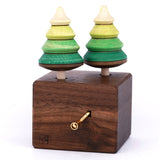 Mader Kreiselmanufaktur forest Edelweiss music box. A wooden wind up musical box with two slots for the green tree shaped spinners on the top.