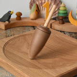 Mader goliath thunderbolt wooden spinning top spinning in motion on an oak spinning plate in the Babipur playroom.