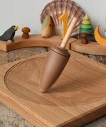 Mader goliath thunderbolt wooden spinning top spinning in motion on an oak spinning plate in the Babipur playroom.