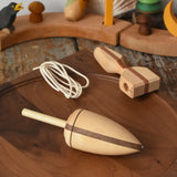 Mader goliath thunderbolt wooden spinning top with starter placed on a walnut spinning plate in the Babipur playroom.