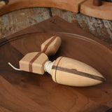 Mader goliath thunderbolt wooden spinning top with starter placed on a walnut spinning plate in the Babipur playroom.