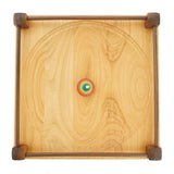Top view of a rainbow spinning top on the Mader 40cm large Manege Spinning Plate on a white background