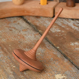 Mader ibis spinning top placed on a wooden desk in the Babipur playroom.
