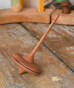 Mader ibis spinning top placed on a wooden desk in the Babipur playroom.
