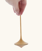 Mader Kreiselmanufaktur 55mm Trumpo Wooden Spinning Top, and adult hand can be seen holding it upright.