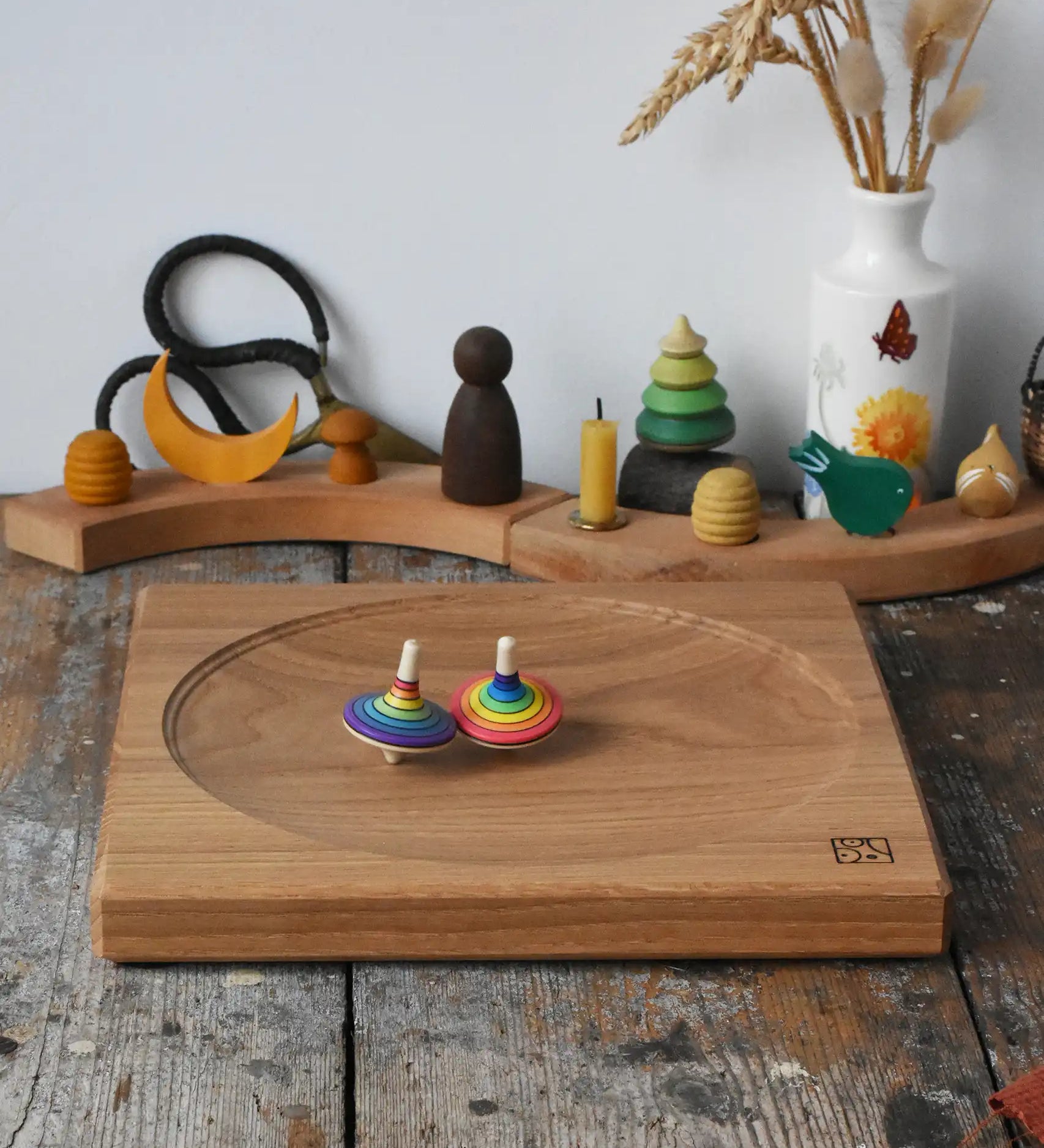 Mader Kreiselmanufaktur 25cm Large Oak Spinning Platewith two rainbow spinning tops in motion in the Babipur playroom. 