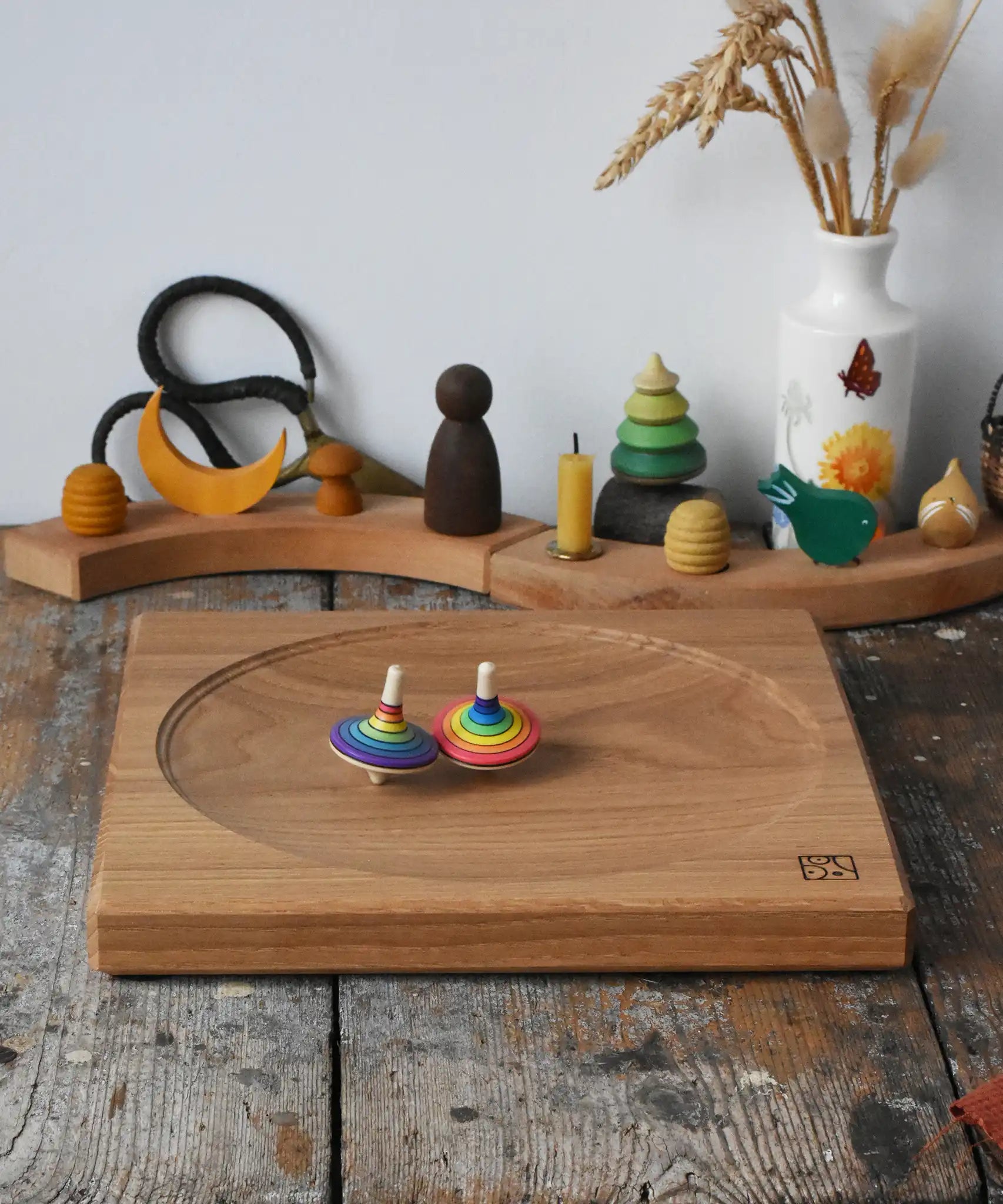 Mader Kreiselmanufaktur 25cm Large Oak Spinning Platewith two rainbow spinning tops in motion in the Babipur playroom. 