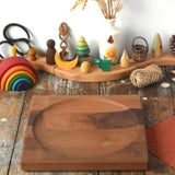 Mader Kreiselmanufaktur Large 25cm Walnut Spinning Plate placed on a wooden surface in the Babipur playroom.