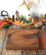 Mader Kreiselmanufaktur Large 25cm Walnut Spinning Plate placed on a wooden surface in the Babipur playroom.