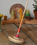 Mader Kreiselmanufaktur large Arabella spinning top placed on a wooden surface in the Babipur playroom. 