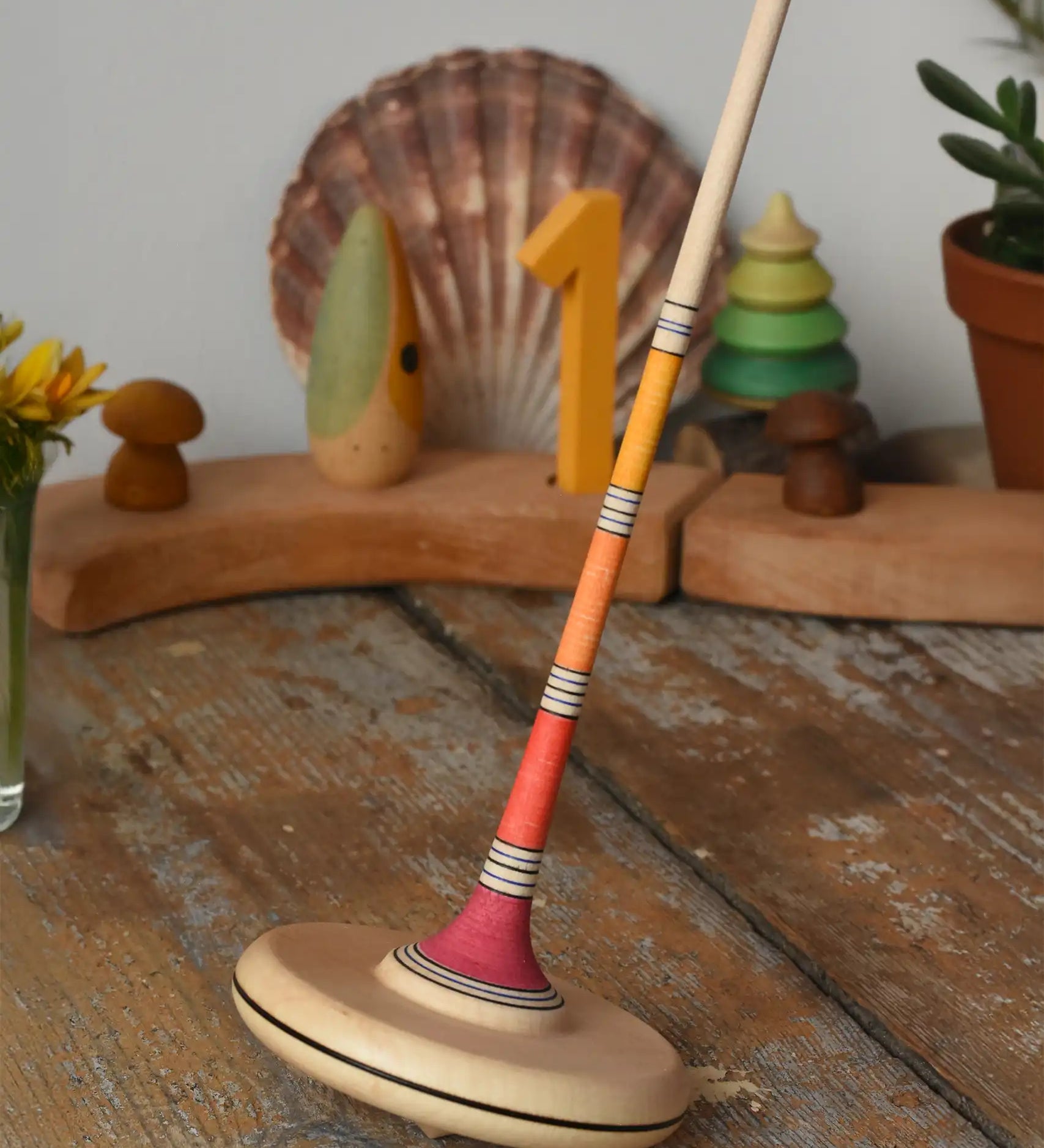 Mader Kreiselmanufaktur large Arabella spinning top placed on a wooden surface in the Babipur playroom. 